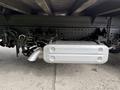 A silver exhaust system mounted underneath the chassis of a 2018 Hino 195 featuring pipes and a rectangular muffler