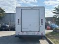 A 2012 Ford E-450 box truck with a white exterior and a closed roll-up rear door