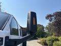 A 2005 GMC C7500 Topkick truck showcasing a side mirror with an orange light indicator attached to a black arm