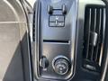 Control panel of a 2020 Chevrolet Silverado with knobs and buttons for headlights and other controls