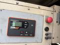 Close-up of a control panel from a Katolight SED60FPJ4 generator featuring buttons for on off auto and run along with a small display screen and a red emergency button