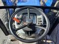 View of the steering wheel and control panel of a 2010 New Holland T4050 tractor