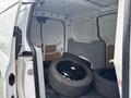 A 2019 Ford Transit Connect van with its rear doors open displaying four black alloy wheels inside