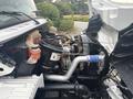 A 2006 Freightliner M2 106 truck engine compartment showcasing a detailed view of the engine components and surrounding machinery