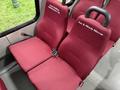 A 2017 Ford E450 van interior featuring two burgundy upholstered passenger seats with seatbelts each labeled with names Ken & Wendy Macrae and Rose Building Maintenance Ltd
