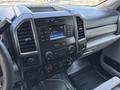 Interior dashboard of a 2017 Ford F-550 featuring audio controls a touchscreen display and climate control knobs