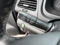 A close-up of the control stalk inside a 2014 Honda CR-V featuring settings for headlights and indicators