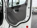 The interior door panel of a 2005 Freightliner M2 106 featuring a gray surface with a handle and armrest