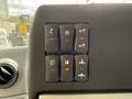 Control panel featuring six buttons with icons for various functions including lights, air conditioning, and equipment operation