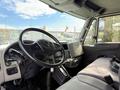 Interior view of a 2014 International TerraStar truck showcasing the steering wheel dashboard and seats