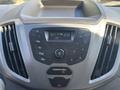 Dashboard of a 2016 Ford Transit 150 featuring a radio display control panel with buttons for radio, AUX, volume, and menu settings