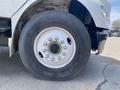 Close-up of a large truck tire mounted on a 2017 Freightliner M2 106 with visible metal rim and lug nuts