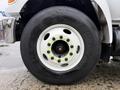 A close-up of a white wheel on a 2011 Ford F-650 featuring a black tire with the Hankook logo and visible lug nuts on the rim