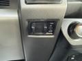Interior controls of a 2020 Ford F-550 including a rocker switch with plus and minus buttons and a dial for adjusting settings