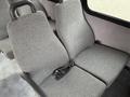 A pair of gray fabric seats in a 2014 Ford Econoline van with a seatbelt attached to one of the seats