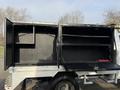 A 2015 Ford F-550 with open service body compartments revealing black interior shelving and storage space