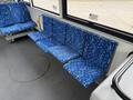 A row of blue patterned seats in a 2018 Grande West Vicinity bus designed for public transportation