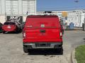 A red 2018 GMC Canyon pickup truck is shown from the rear with a Leer camper shell and the GMC logo visible on the tailgate