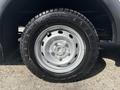 Close-up view of a silver wheel with a black tire mounted on a 2018 Ford Transit-350