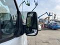 A 2016 Ford Transit 150 van with a side mirror visible in the foreground