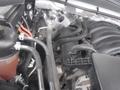 A close-up view of the engine compartment of a 2015 Chevrolet Silverado 1500 highlighting various engine components and hoses