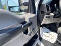 Interior view of a 2017 Ford F-250 SD showing the driver's side door panel with a door handle and control switches for windows and mirrors