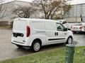 A white 2017 RAM ProMaster City van parked with its side facing the viewer featuring sliding side doors and a simple, modern design