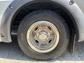 Close-up of a chrome wheel rim and tire from a 2020 Chevrolet Express showing tread details and the textured sidewall