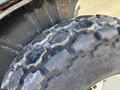 A close-up view of a tire from a 2010 New Holland T4050 featuring a rugged tread design and visible wear from use