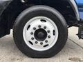 A close-up of a 2017 Autocar Xpert truck tire and wheel showcasing a white rim with multiple bolts and a black tire tread