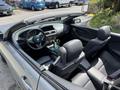2004 BMW 6-Series convertible with a black leather interior featuring a steering wheel gear shift and two front seats visible