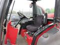 Interior of a 2013 Toro Grounds Master 5910 featuring a black seat and steering wheel with controls on the console