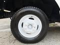 A close-up view of a white wheel and tire from a 2012 Ford Econoline showcasing the tire tread and rim design