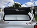 A 2018 Chevrolet Colorado with an open truck bed cover revealing the storage space inside