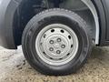 A close-up view of a wheel from a 2023 RAM Promaster 3500 featuring a Nexen tire and a silver multi-spoke rim
