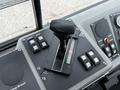 The control panel of a 2012 Global M4 featuring a gear shift lever in the center and several buttons for various functions