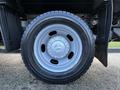 A close-up of a gray wheel of a 2021 RAM 5500 showcasing the tire tread and wheel rim design