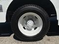 Close-up of a white wheel and tire from a 2019 Freightliner MT45 showing the rim and lug nuts