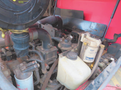 A 2013 Toro Grounds Master 5910 engine with visible components including hoses a filter and a fluid reservoir