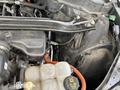 A 2021 Ford Explorer engine with exposed components including hoses wires and a coolant reservoir
