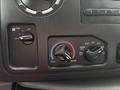 The control panel of a 2017 Ford Econoline includes knobs for fan speed and temperature settings with labels for cool and warm