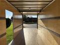 A 2022 Lion Lion6 truck interior with wooden paneling and metal track systems along the walls