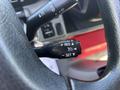 Close-up of a vehicle's steering wheel controls featuring a cruise control lever with buttons for cancel, resume, and set functions