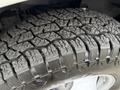 Close-up of a tire with deep treads specifically designed for traction and durability on a 2015 GMC Savana