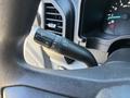 A close-up view of the turn signal lever and dashboard of a 2019 Ford F-150 showing the speedometer and various controls