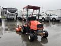 A 2012 Kubota F3680 riding mower with a red body and a rear-mounted mower deck parked on a wet surface