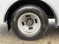 Close-up view of a 2020 Chevrolet Express wheel featuring a black Michelin tire mounted on a silver rim with visible lug nuts