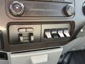 Interior control panel of a 2015 Ford F-550 featuring dials and switches for various auxiliary functions