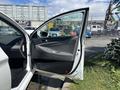 A 2014 Hyundai Sonata with an open front door revealing the interior and dashboard