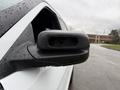 Close-up of the side mirror of a 2019 Ford Explorer with raindrops on its surface